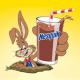 El conejo de NESQUIK sale de un agujero con un vaso de leche de chocolate.